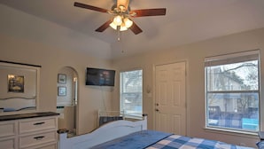 A bedroom with a bed, a ceiling fan, a dresser, a television, and a window with blinds. - San Antonio Home w/ Pool & Hot Tub Near Seaworld! (San Antonio)
