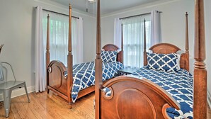 A four-poster bed with a wooden frame and a blue and white patterned bedspread. - San Antonio Home w/ Pvt. Yard, 5 Mi to Downtown! (San Antonio)