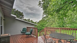 A wooden deck with a table and chairs, a small table, and a green chair. - San Antonio Home w/ Pvt. Yard, 5 Mi to Downtown! (San Antonio)
