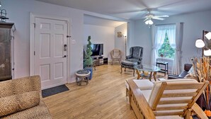 A living room with a sofa, chairs, a TV, a ceiling fan, and a window with curtains. - San Antonio Home w/ Pvt. Yard, 5 Mi to Downtown! (San Antonio)