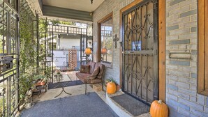 A porch with a cushioned seating area, a decorative door, and potted plants. - San Antonio Rental w/ Courtyard: Walk to Riverwalk (San Antonio)