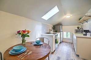 A modern kitchen with white cabinetry, a built-in oven, and a window. - Dtwn Golden Apt < 9 Mi to Red Rocks Amphitheater! (Golden)