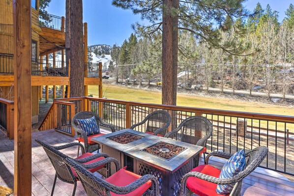A wooden deck with wicker furniture and a fire pit. - Walk to Ski Lift: Gem w/ Hot Tub in Big Bear Lake (Big Bear Lake)