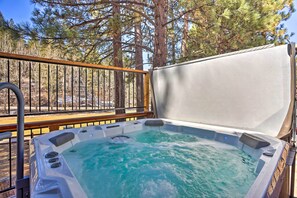 A hot tub with a wooden deck and metal railing, surrounded by trees. - Walk to Ski Lift: Gem w/ Hot Tub in Big Bear Lake (Big Bear Lake)