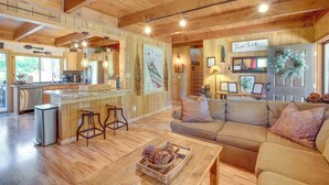 A spacious living area with a wooden ceiling, a kitchen with a bar, and a cozy seating area. - 10 Mi to Ski Slopes: South Lake Tahoe Home (South Lake Tahoe)
