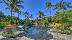 A pool area with a hot tub, surrounded by tropical plants and palm trees. - Luxe Maunalani Resort Condo w/ Pool + Beach Access (Kamuela)