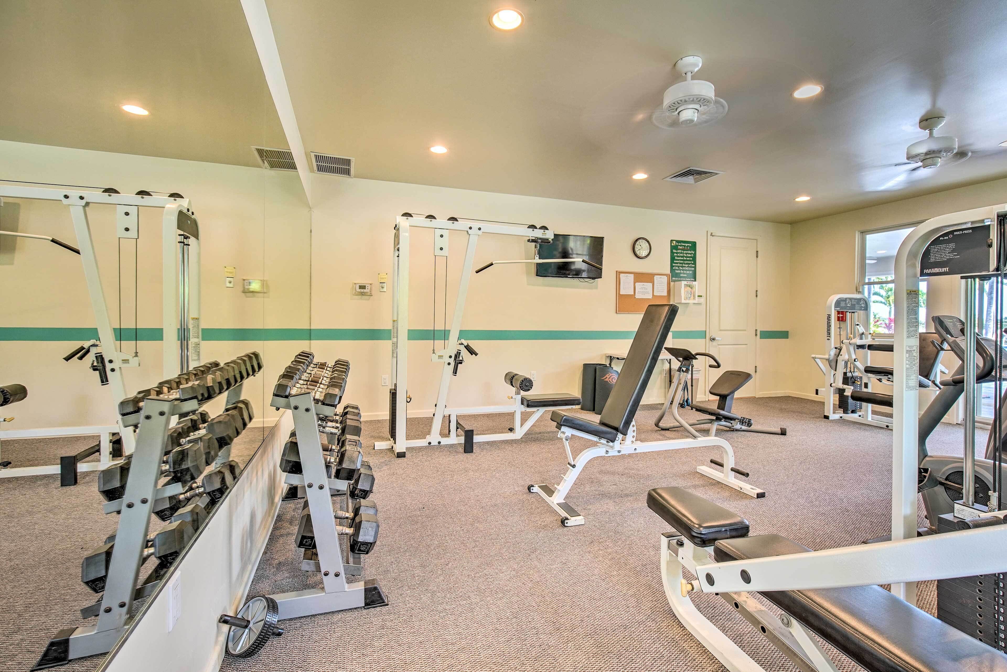 A gym with weight machines, benches, and a treadmill.