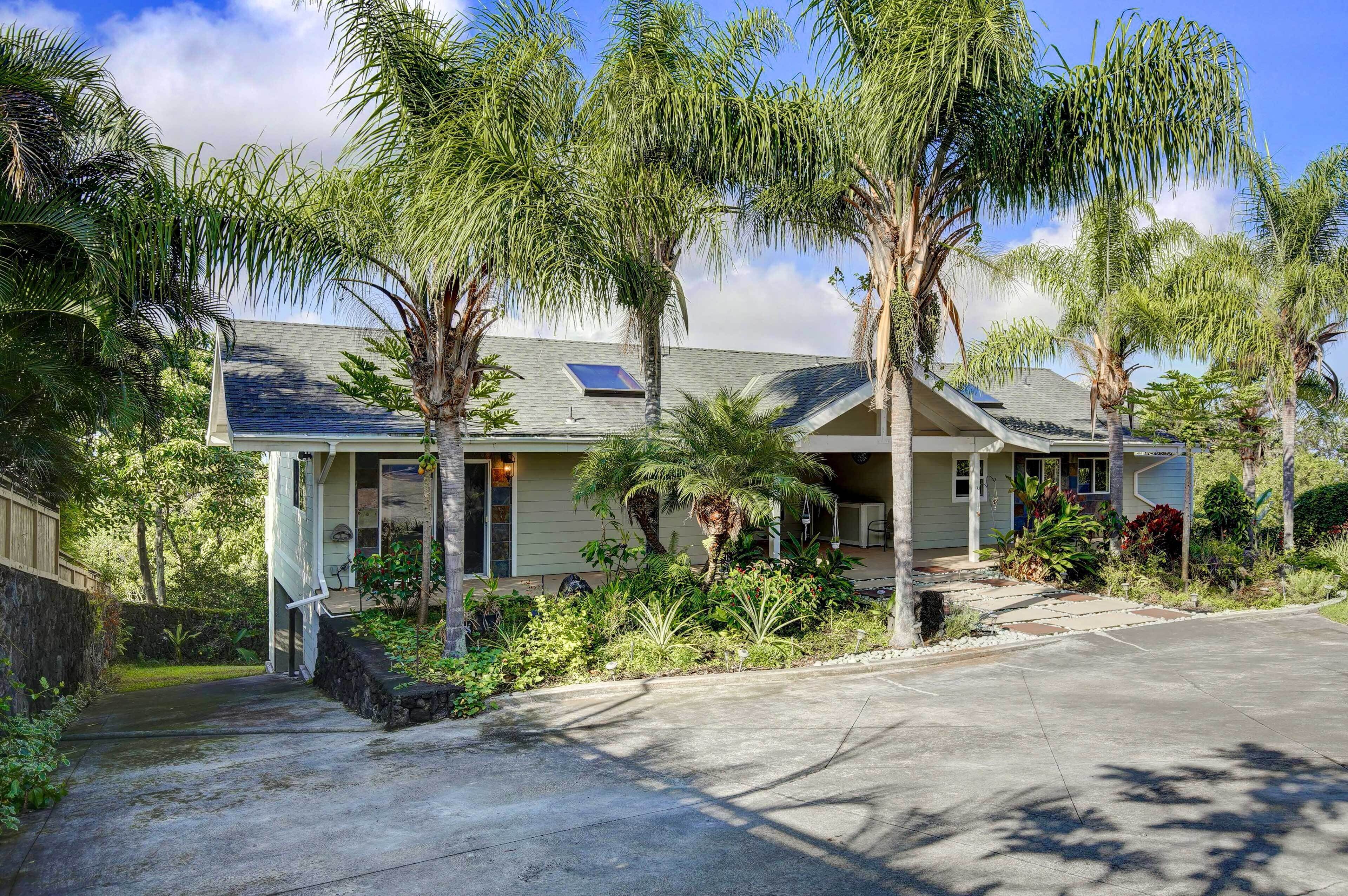 A single-story house with a sloped roof, solar panels, and a front porch.