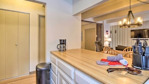 A modern kitchen with a wooden countertop, a coffee maker, and a set of knives. - 1 Mi to Dillon Reservoir: Condo Retreat in Frisco! (Frisco)