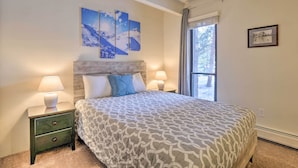 A bedroom with a large bed, two bedside tables with lamps, a window with curtains, and three wall-mounted paintings. - 1 Mi to Dillon Reservoir: Condo Retreat in Frisco! (Frisco)