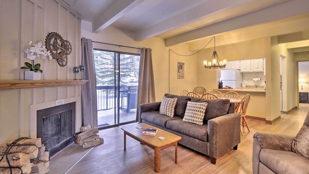 A living room with a fireplace, sofa, coffee table, and a view of the outdoors. - 1 Mi to Dillon Reservoir: Condo Retreat in Frisco! (Frisco)