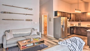 A modern living room with a sofa, coffee table, and skis on the wall. - Buena Vista Condo: 1/2 Mile to River & Main St! (Buena Vista)