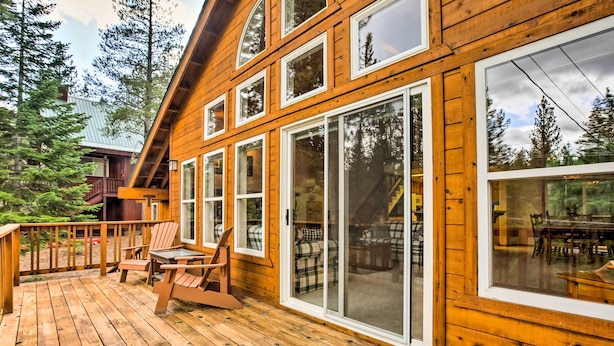A wooden cabin with large windows and a deck area with outdoor furniture. - Hot Tub Access, Near Skiing: Tahoe Donner Cabin (Truckee)