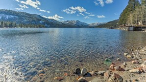 A clear lake with a rocky shoreline and a mountain backdrop. - Hot Tub Access, Near Skiing: Tahoe Donner Cabin (Truckee)