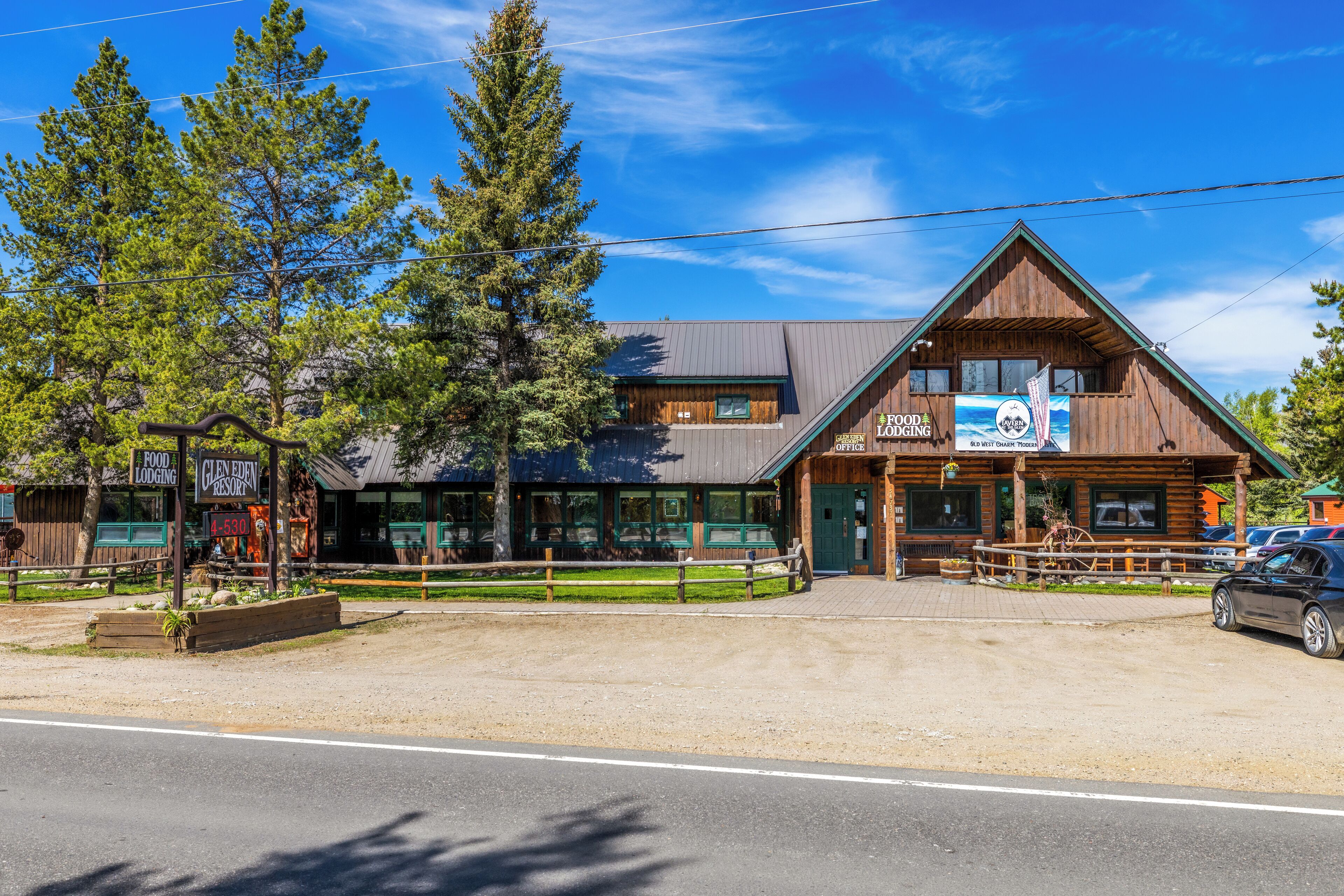 A rustic wooden building with a sign for Glen Eden Resort and a food lodge.