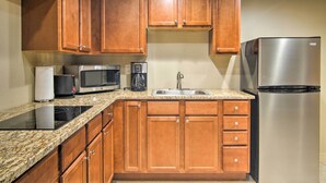 A kitchen with wooden cabinets, stainless steel appliances, and granite countertops. - CO Springs Apartment < 6 Mi to Garden of the Gods! (Colorado Springs)