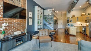 A modern kitchen with wooden cabinets, a built-in oven, and a stainless steel refrigerator. - 'kentucky Bourbon Loft' ~ Downtown Louisville (Louisville)