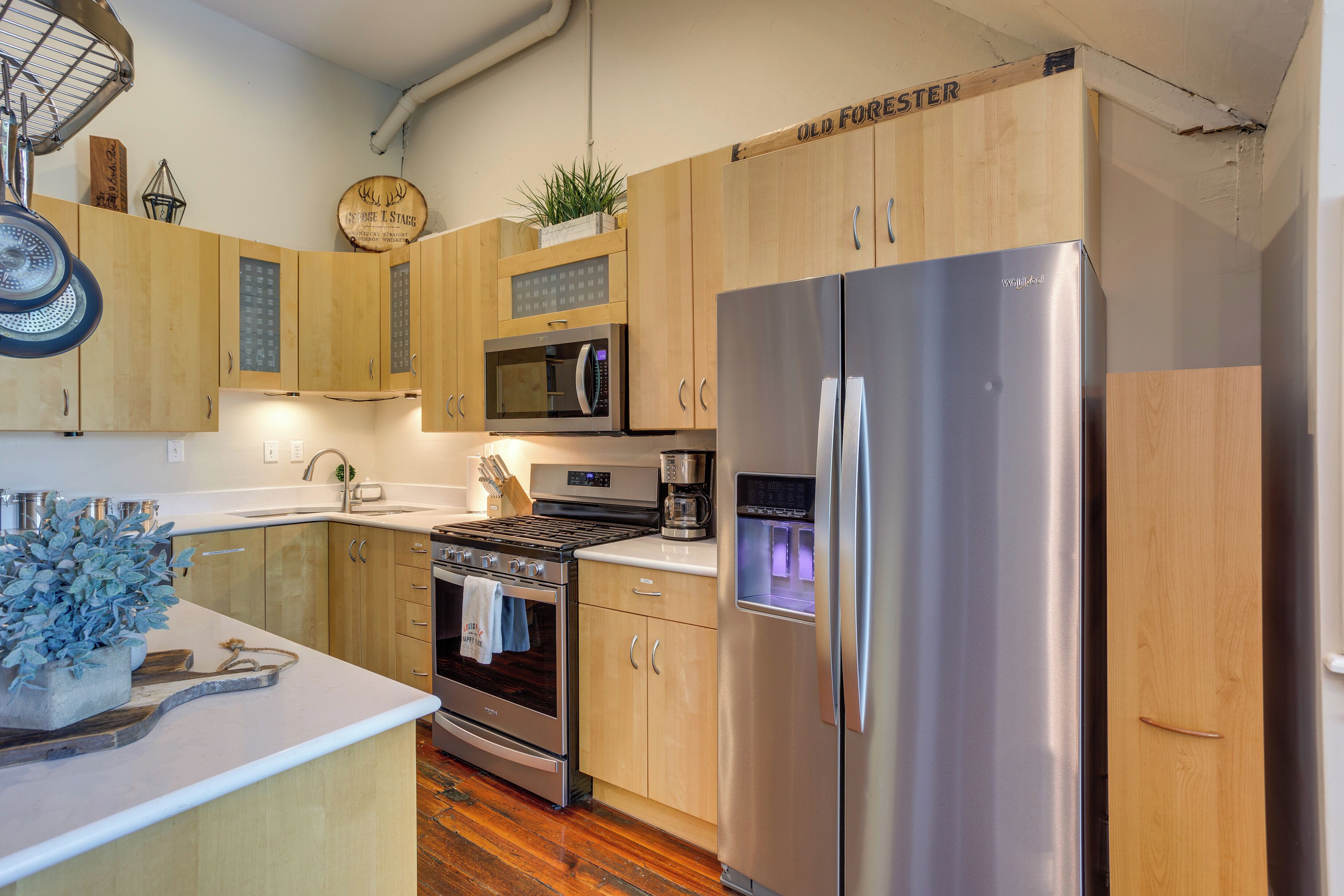 A modern kitchen with wooden cabinets, stainless steel appliances, and a built-in oven.