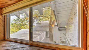 A room with a large window overlooking a tree and a building. - Cozy Studio Near Hiking & Skiing, Walk to Downtown (Mount Shasta)