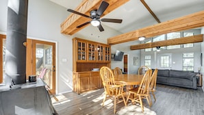 A spacious living area with a dining table, wooden chairs, a sofa, and a ceiling fan. - Canyon Lake House w/ Porch, Views + Private Gazebo (Canyon Lake)