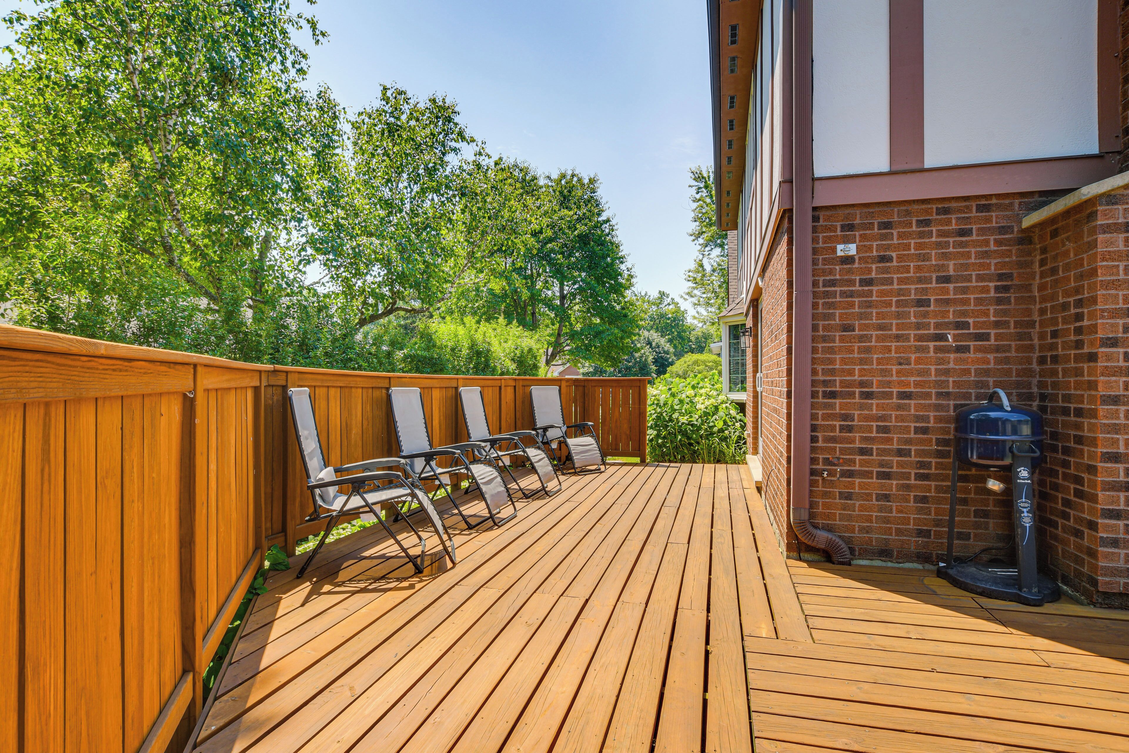 A wooden deck with chairs and a water fountain.