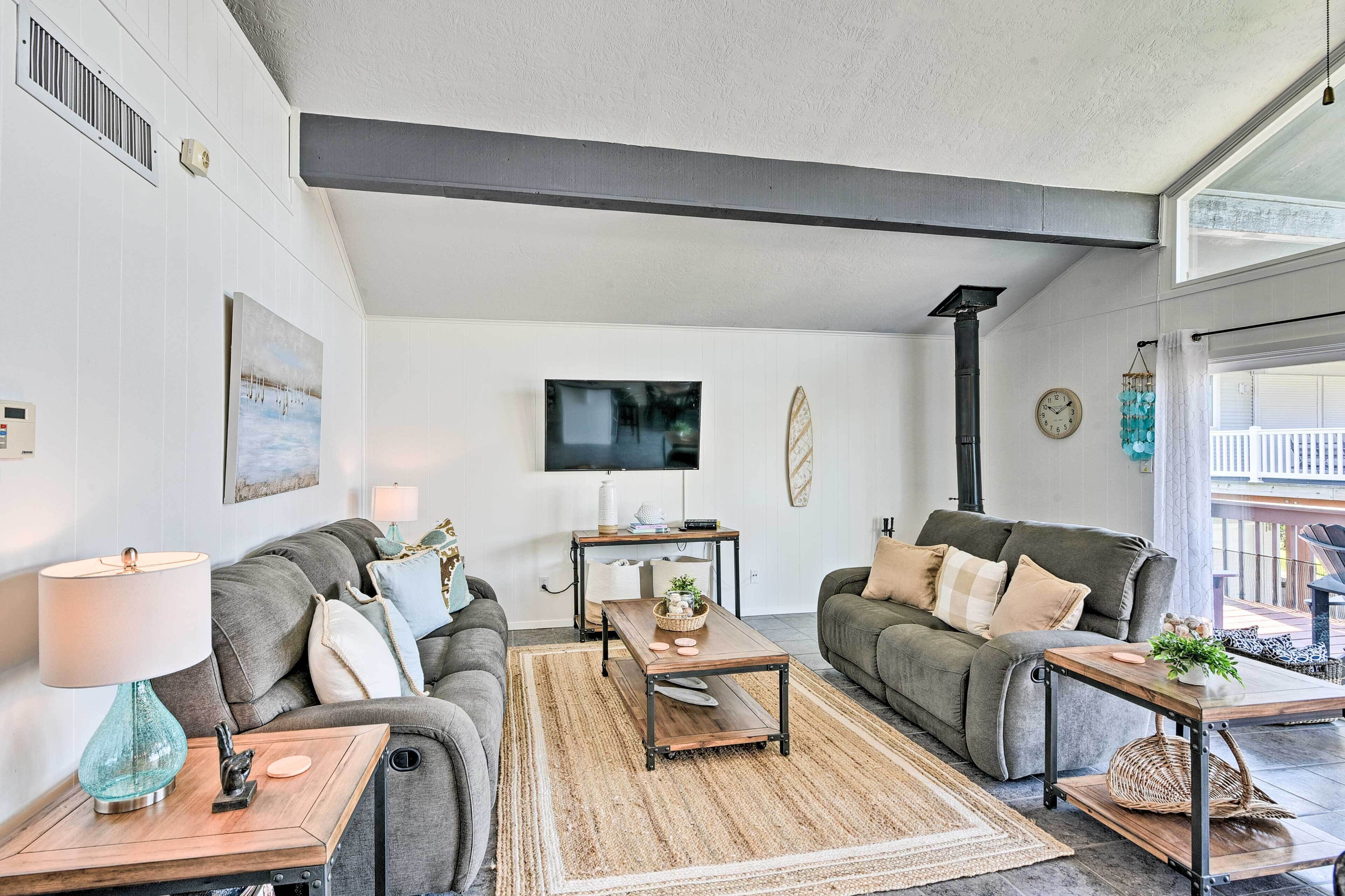 A modern living room with two sofas, a coffee table, and a TV.