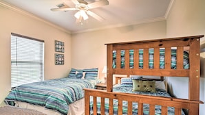 A bedroom with two beds, a ceiling fan, and a window with blinds. - < 1 Mi to Beach: Salty Dog House in Galveston! (Galveston)