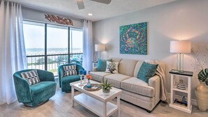 A modern living room with a sofa, two armchairs, a coffee table, and a ceiling fan. - Ocean-view Balcony: Family Gem on Seawall Blvd! (Galveston)