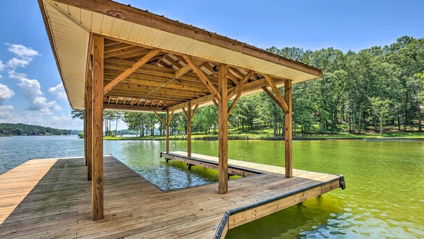 A wooden dock extending into a lake, with a covered pavilion structure. - The Lake Escape: Boat Dock, Fire Pit, Kayak! (Cropwell)