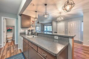A modern kitchen with granite countertops, stainless steel appliances, and pendant lighting. - Steamboat Springs Townhome < 2 Mi to Lifts! (Steamboat Springs)