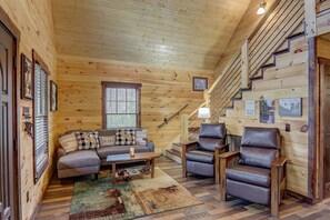 Relax in this inviting living room with a sofa set, armchairs, and a coffee table.