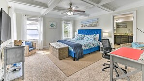A bedroom with a large bed, a desk, a chair, a ceiling fan, and a window with curtains. - Half-mi to Inlet Beach: Home w/ Grill & Fire Pit (Panama City Beach)