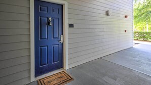 A blue door with a doormat, a mailbox, and an exit sign on a house exterior. - Sun-soaked Kissimmee Gem w/ Resort Amenities! (Kissimmee)