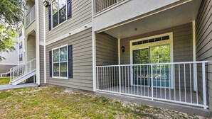 A two-story building with a covered porch and a small pool. - Sun-soaked Kissimmee Gem w/ Resort Amenities! (Kissimmee)