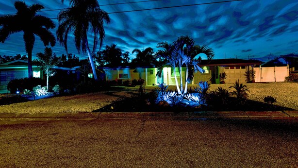A residential area with houses, palm trees, and a clear sky. - Backyard Oasis! Waterfront Haven in Bradenton (Bradenton)