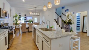 A modern kitchen with granite countertops, stainless steel appliances, and a central island. - Ocean View Home w/ Beach Shuttle, 5 Mi to Coast! (Frankford)