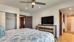 A bedroom with a bed, a television, a ceiling fan, and a bathroom with a shower. - Enjoy Luxury By Tennis/coachella/stagecoach (Indian Wells)