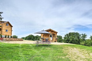 Situated in a lush landscape, this cabin offers a peaceful retreat with a porch and picnic area.