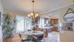 A spacious kitchen with a dining area, featuring a central island, modern appliances, and ample natural light. - Palm Desert Escape w/ Patio & Shared Pool! (Palm Desert)