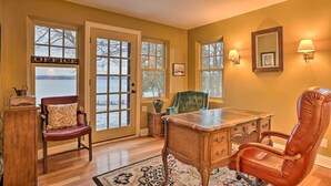 A room with a desk, two chairs, a wooden podium, and a rug. - Stunning South Hero Home on Lake Champlain w/ View (South Hero)