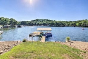 A dock extending into a lake with a wooden pier and a covered area. - Sunrise Beach Home w/ Boat Dock on the Ozarks (Sunrise Beach)