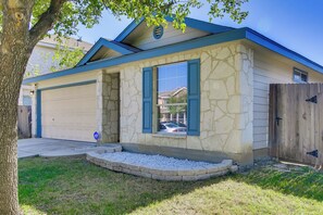 A house with a stone facade, a garage, and a wooden fence. - San Antonio Abode w/ Yard < 4 Mi to Lackland (San Antonio)