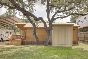 A wooden house with a covered porch and a small shed. - Couples Cabin w/ Luxury Deck, 1 Mi to Canyon Lake! (Canyon Lake)