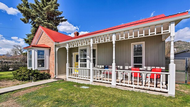 A two-story house with a red roof and white porch. - Chic Downtown Home w/ Grill, Steps to Main Street! (Buena Vista)