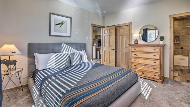 A bedroom with a bed, a dresser, a mirror, a lamp, and a framed picture on the wall. - Frisco Condo w/ Balcony: 7 Mi to Copper Mountain! (Frisco)