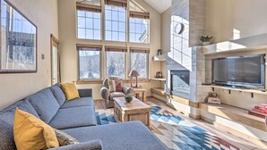 A spacious living room with a large sectional sofa, a fireplace, and a television. - Frisco Condo w/ Balcony: 7 Mi to Copper Mountain! (Frisco)