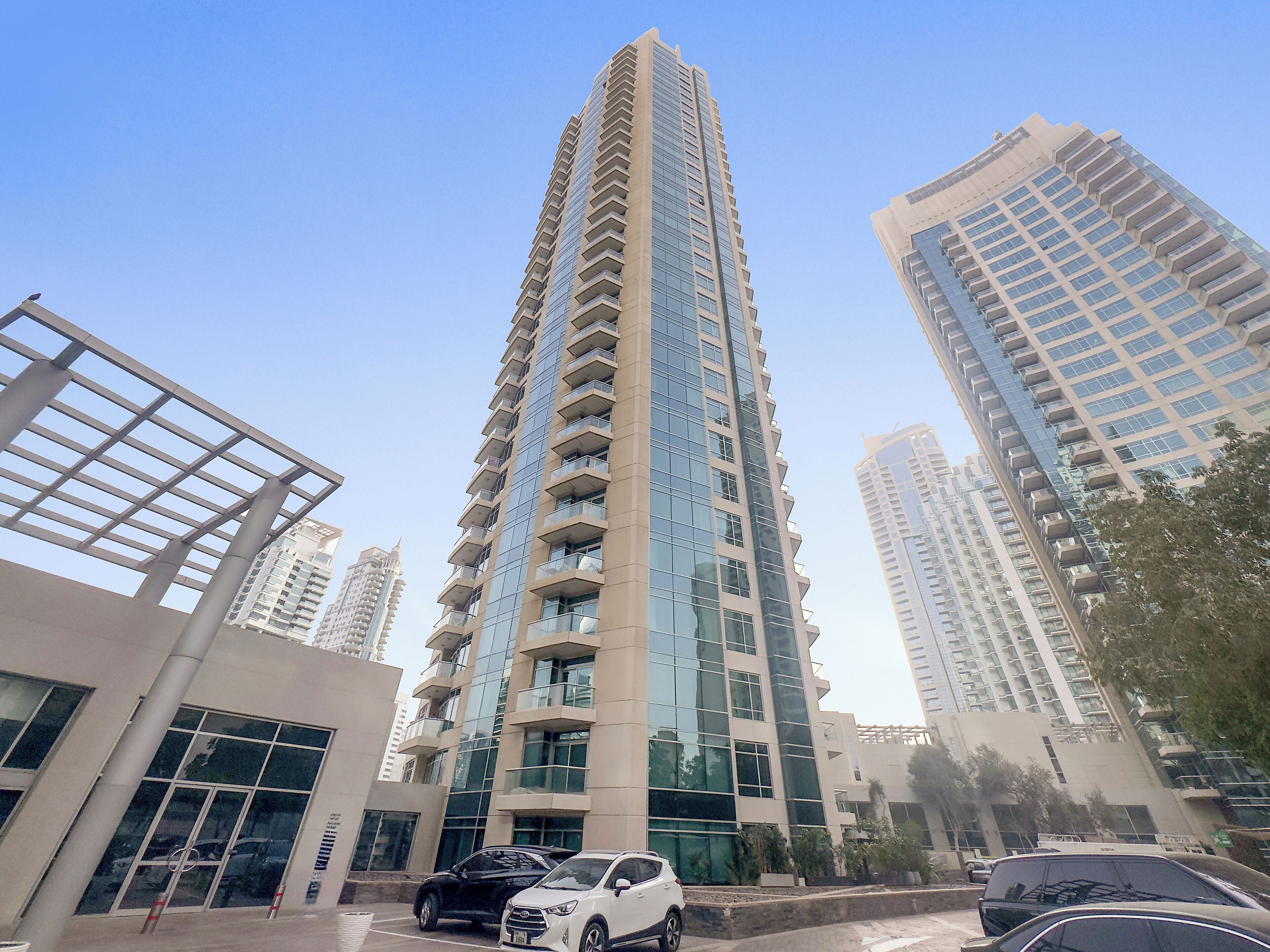 A high-rise building with multiple balconies, large windows, and a modern architectural design.