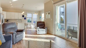 A spacious living area with two sofas, a dining table, and a kitchen in the background. - Gulf Shores Home w/ Shared Pool, 2 Blocks to Beach (Gulf Shores)