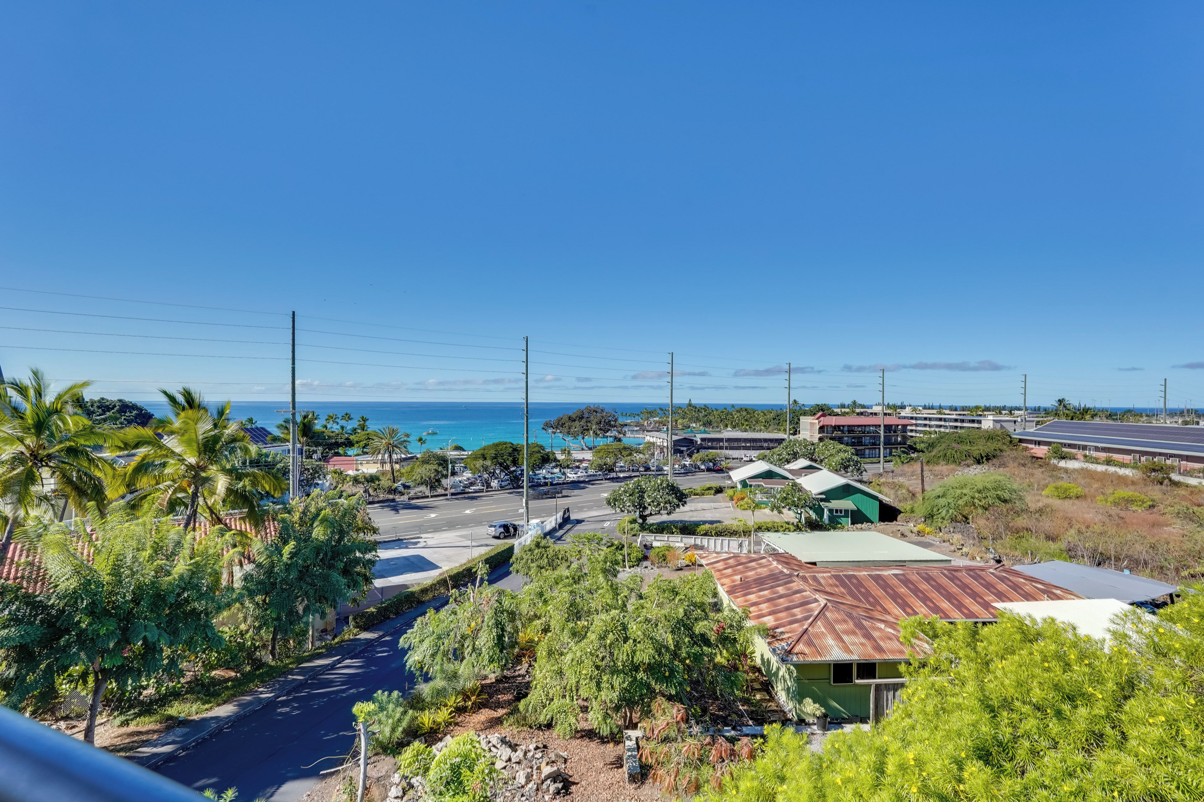 A coastal area with a road, buildings, and a view of the ocean.