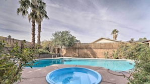 A backyard with a swimming pool, a hot tub, and a wooden fence. - 'vegas Oasis' Home w/ Pool & Spa: 7 Miles to Strip (Las Vegas)